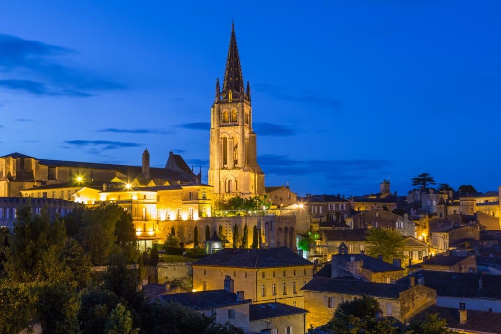 View over St. Emilion town rooftops and church at dusk, Bordeaux region.